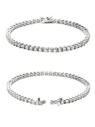 Tennis bracelet features sparkling cubic zirconia crystals set in silver-toned metal. Safety clasp.