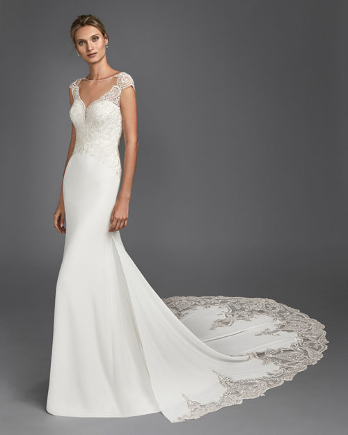 Mermaid-style crepe Georgette and lace wedding dress with deep-plunge neckline and low back.