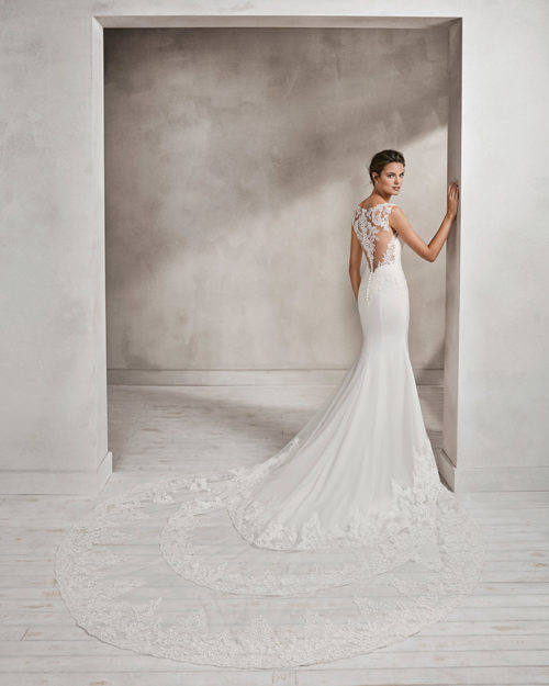 Mermaid-style crepe and lace wedding dress with sweetheart neckline and lace back.