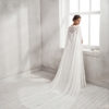 Mermaid-style crepe Georgette and guipure lace wedding dress with sweetheart neckline and cape.