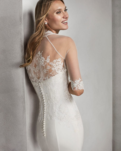 Mermaid-style beaded lace and crepe strapless wedding dress.