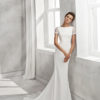 Mermaid-style crepe wedding dress with short sleeves, bateau neckline and guipure lace back.