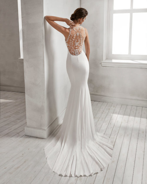 Mermaid-style crepe Georgette wedding dress with halter neckline and beaded back.