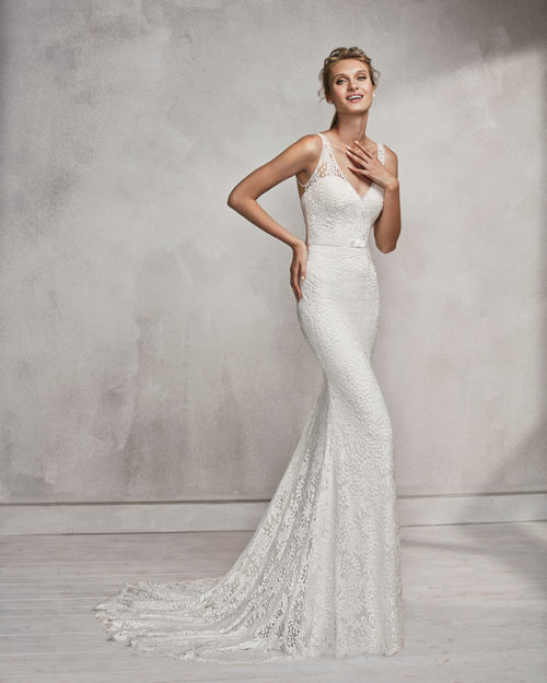 Mermaid-style beaded lace wedding dress with V-neckline and low back.