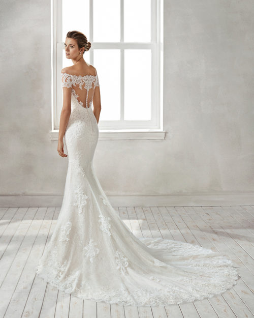 Mermaid-style lace wedding dress with off-the-shoulder neckline and lace appliqués, in nude and natural