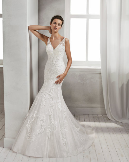 Mermaid-style beaded lace wedding dress with low back, in ivory and natural.