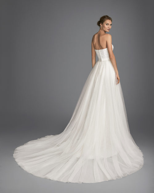 Mermaid-style beaded lace wedding dress with sweetheart neckline and tulle overskirt.