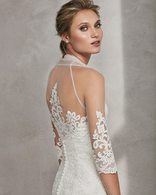 Mermaid-style beaded lace wedding dress with V-neckline and low back.