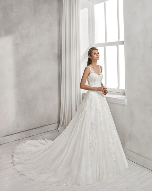 A-line beaded lace and tulle wedding dress with V-neckline and low back.