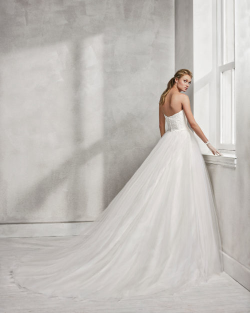 Princess-style beaded lace and tulle strapless wedding dress.