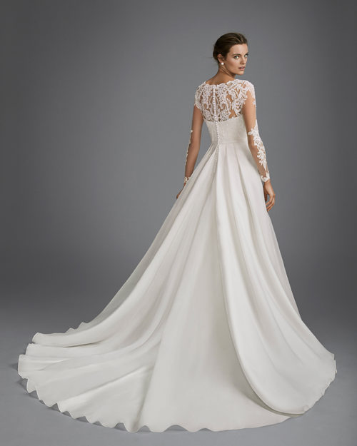 Princess style beaded lace and organza wedding dress with long sleeves and illusion neckline.