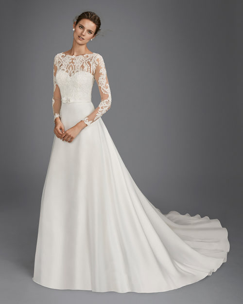 Princess style beaded lace and organza wedding dress with long sleeves and illusion neckline.