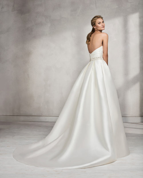 Classic-style mikado strapless wedding dress with beaded belt.