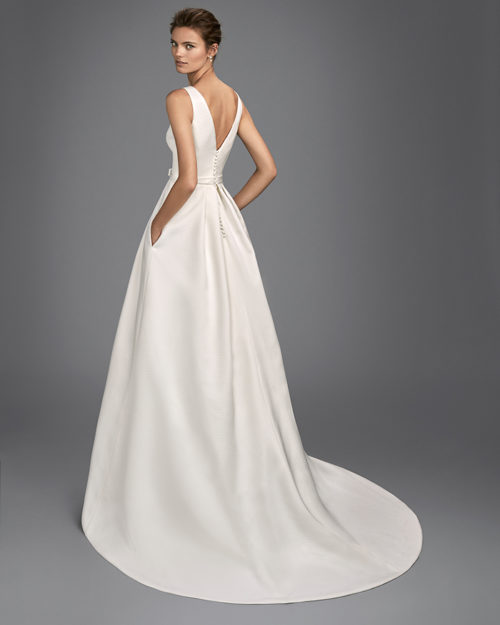 Classic-style piqu_ wedding dress with bateau neckline, V-back and bow at waist.