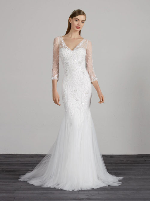 Spectacular tulle and beading mermaid dress. A design that shimmers with its own light and accentuates the sensuality of the neckline and back with illusions. A dress with low waist, v-neck and 3/4 sleeves.
