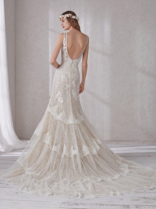 The most romantic seductiveness and the most delicate fabrics take centre stage in this spectacular evasé design. A dress that slims the silhouette to the maximum by enhancing femininity using illusions and the floral nuances of the lace. A design with low waist, bateau neckline and scoop back.