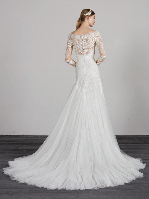 Sensational soft tulle evasé dress with lace appliqués both on the skirt with low waist and on the spectacular bodice framed by a modern v-neck with back and long sleeves crafted in tulle and lace with illusions
