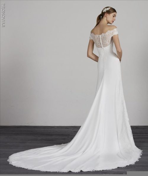 Wonderful evasé dress in crepe with a low waist and a beautiful off-the-shoulder effect sweetheart neckline in semi-sheer lace, combined with wrap-around off-the-shoulder straps.