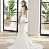 Sheath-style wedding dress in lace and stretch crepe with beaded neckline. Bateau neckline and low back. With shaper lining.