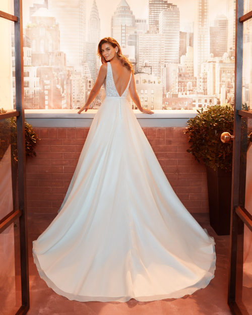 LUCER Classic beaded lace wedding dress with deep-plunge neckline and low V-back.
