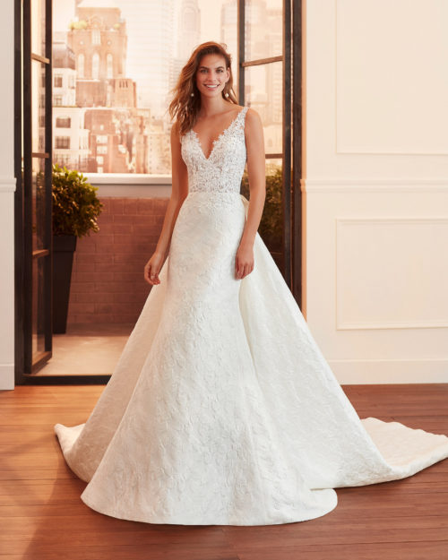 LUCIANA Sheath-style wedding dress and train in brocade and lace with beading, V-neckline and back with sheer inserts.